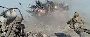 Movie still from “Battle Los Angeles” (2011), directed by Jonathan Liebesman – An explosion is seen in the background of a demolished building; Extreme Wide shot, Low angle
