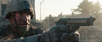 Movie still from “Battle Los Angeles” (2011), directed by Jonathan Liebesman – A soldier is holding a gun in his hand; Close Up shot, Low angle