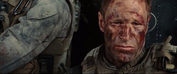 Movie still from “Battle Los Angeles” (2011), directed by Jonathan Liebesman – A person with a face covered in blood; Close Up shot, Over the shoulder angle