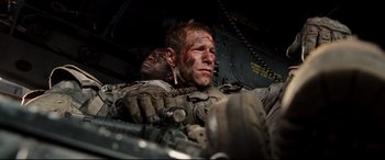 Movie still from “Battle Los Angeles” (2011), directed by Jonathan Liebesman – Two men in military fatigues are laying on a plane; Close Up shot, High angle