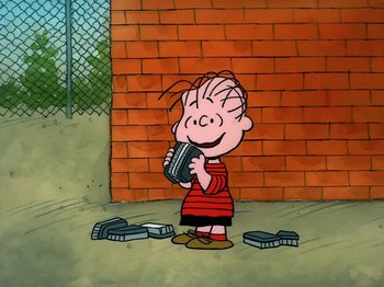 Movie still from “Be My Valentine, Charlie Brown” (1975), directed by Phil Roman – A cartoon of a boy holding a pair of shoes in front of a brick wall; Extreme Wide shot, High angle