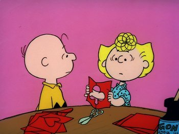 Movie still from “Be My Valentine, Charlie Brown” (1975), directed by Phil Roman – A couple of people sitting at a table with a pair of scissors; Medium shot, High angle