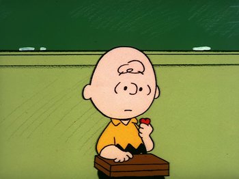 Movie still from “Be My Valentine, Charlie Brown” (1975), directed by Phil Roman – Charlie brown holding a piece of paper in front of a chalkboard; Medium shot, High angle