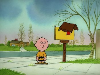 Movie still from “Be My Valentine, Charlie Brown” (1975), directed by Phil Roman – A charlie brown character standing in front of a mailbox; Wide shot, Low angle