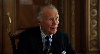 Movie still from “Bean” (1997), directed by Mel Smith – An older man wearing a suit and tie; Close Up shot, Low angle
