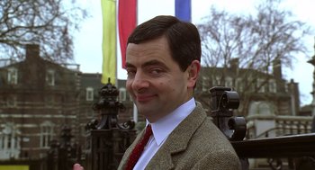 Movie still from “Bean” (1997), directed by Mel Smith – A person wearing a suit and tie; Close Up shot, Low angle