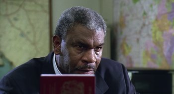 Movie still from “Bean” (1997), directed by Mel Smith – An older man looking at a computer screen; Close Up shot, Low angle