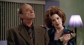 Movie still from “Bean” (1997), directed by Mel Smith – A man and a woman standing next to each other; Medium shot, Low angle