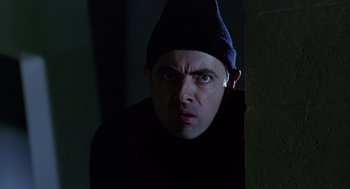 Movie still from “Bean” (1997), directed by Mel Smith – A person wearing a hat; Close Up shot, Low angle