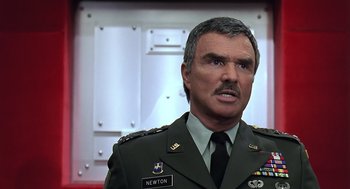 Movie still from “Bean” (1997), directed by Mel Smith – A man in a military uniform is looking at the camera; Close Up shot, Low angle