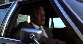 Movie still from “Bean” (1997), directed by Mel Smith – A man sitting in the passenger seat of a car; Close Up shot, Low angle