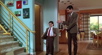 Movie still from “Bean” (1997), directed by Mel Smith – A man and a boy wearing suits and ties; Wide shot, Over the shoulder angle