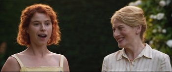 Movie still from “Beast” (2017), directed by Michael Pearce – Two women standing next to each other in front of trees; Close Up shot, Over the shoulder angle