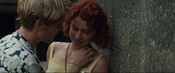 Movie still from “Beast” (2017), directed by Michael Pearce – A woman with red curly hair is smiling at a man; Close Up shot, Overhead angle