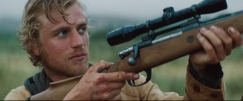 Movie still from “Beast” (2017), directed by Michael Pearce – A person with a rifle; Close Up shot, Over the shoulder angle