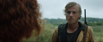 Movie still from “Beast” (2017), directed by Michael Pearce – A man with long hair and a beard standing next to a woman; Close Up shot, Over the shoulder angle