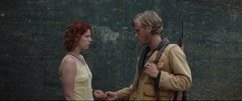 Movie still from “Beast” (2017), directed by Michael Pearce – A man and a woman holding hands in front of a stone wall; Medium shot, Low angle