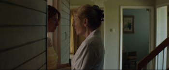 Movie still from “Beast” (2017), directed by Michael Pearce – Two women standing in front of each other in front of a door; Medium shot, Over the shoulder angle