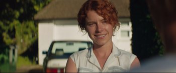 Movie still from “Beast” (2017), directed by Michael Pearce – A person with red hair smiling; Close Up shot, Over the shoulder angle