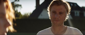 Movie still from “Beast” (2017), directed by Michael Pearce – A person wearing a white t - shirt; Close Up shot, Over the shoulder angle