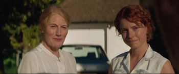 Movie still from “Beast” (2017), directed by Michael Pearce – Two women standing next to each other in front of a car; Close Up shot, Over the shoulder angle