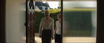 Movie still from “Beast” (2017), directed by Michael Pearce – Two women are walking out of a house; Medium shot, Low angle
