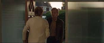 Movie still from “Beast” (2017), directed by Michael Pearce – A man and a woman standing in front of a door; Medium shot, Over the shoulder angle