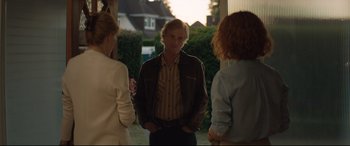 Movie still from “Beast” (2017), directed by Michael Pearce – A man standing next to two other people; Medium shot, Over the shoulder angle