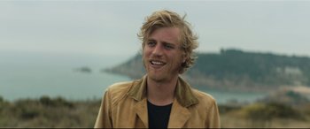 Movie still from “Beast” (2017), directed by Michael Pearce – A person wearing a jacket near a body of water; Close Up shot, Low angle