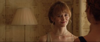 Movie still from “Beast” (2017), directed by Michael Pearce – A beautiful young lady wearing a white tank top; Close Up shot, Over the shoulder angle
