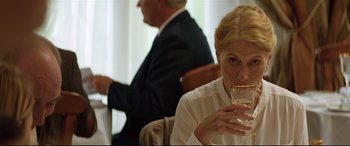 Movie still from “Beast” (2017), directed by Michael Pearce – An older woman drinking a glass of water while sitting next to a man; Close Up shot, Over the shoulder angle