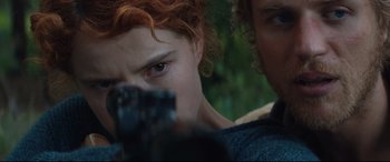 Movie still from “Beast” (2017), directed by Michael Pearce – A person holding a gun; Close Up shot, Over the shoulder angle