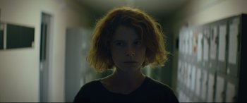 Movie still from “Beast” (2017), directed by Michael Pearce – A woman with red curly hair is staring at the camera; Close Up shot, Low angle
