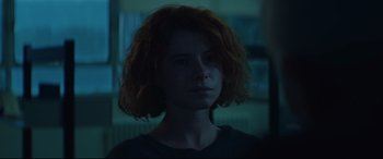 Movie still from “Beast” (2017), directed by Michael Pearce – A woman with red curly hair stares into the camera; Close Up shot, Over the shoulder angle