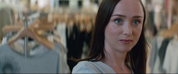 Movie still from “Beast” (2017), directed by Michael Pearce – A woman's face in front of a row of clothes; Close Up shot, Over the shoulder angle