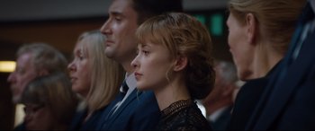 Movie still from “Beast” (2017), directed by Michael Pearce – A woman in a black dress and a man in a blue suit; Close Up shot, Low angle