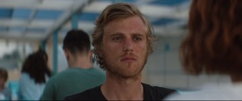 Movie still from “Beast” (2017), directed by Michael Pearce – A person wearing a black t - shirt; Close Up shot, Over the shoulder angle