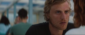 Movie still from “Beast” (2017), directed by Michael Pearce – A man's face with a blurry background behind him; Close Up shot, Over the shoulder angle