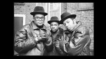 Movie still from “Beastie Boys Story” (2020), directed by Spike Jonze – A black and white photo of three men wearing hats; Medium shot, Low angle