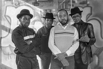 Movie still from “Beastie Boys Story” (2020), directed by Spike Jonze – A black and white photo of a group of men in hats; Medium shot, Low angle