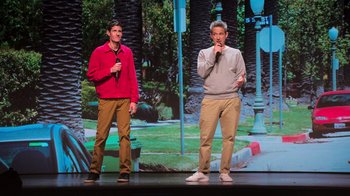 Movie still from “Beastie Boys Story” (2020), directed by Spike Jonze – A couple of men standing next to each other on a stage; Wide shot, High angle