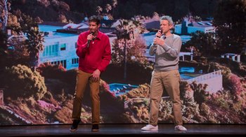 Movie still from “Beastie Boys Story” (2020), directed by Spike Jonze – A couple of men standing next to each other on a stage; Wide shot, High angle