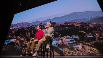 Movie still from “Beastie Boys Story” (2020), directed by Spike Jonze – Two men are sitting on stools on a stage; Wide shot, Low angle