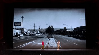 Movie still from “Beastie Boys Story” (2020), directed by Spike Jonze – Two men are standing in front of an empty street; Extreme Wide shot, High angle