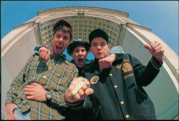 Movie still from “Beastie Boys Story” (2020), directed by Spike Jonze – A group of young men standing next to each other in front of a building; Medium shot, Low angle