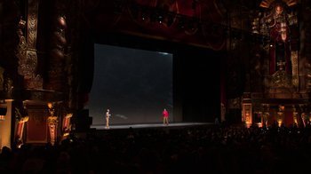 Movie still from “Beastie Boys Story” (2020), directed by Spike Jonze – Two people are on stage in front of a large screen; Extreme Wide shot, High angle