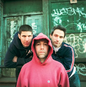 Movie still from “Beastie Boys Story” (2020), directed by Spike Jonze – A group of men standing next to each other in front of a building; Close Up shot, Overhead angle