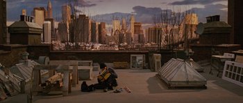 A man sitting on the ground holding a guitar