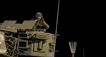 Movie still from “Beaufort” (2007), directed by Joseph Cedar – A man in a military uniform on top of an armored vehicle; Wide shot, Low angle