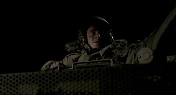 Movie still from “Beaufort” (2007), directed by Joseph Cedar – A man in a helmet is sitting in a vehicle; Medium shot, Low angle
